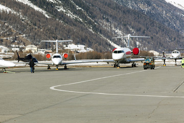 Private jets, planes and helicopters in the airport of St Moritz Switzerland in the alps