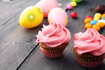 Tasty cupcakes on wooden background. Birthday cupcake in pink color