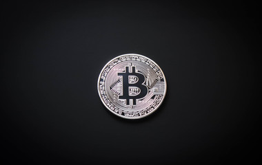 silver coin bitcoin on a black background