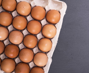 raw eggs in eggshell on paper tray