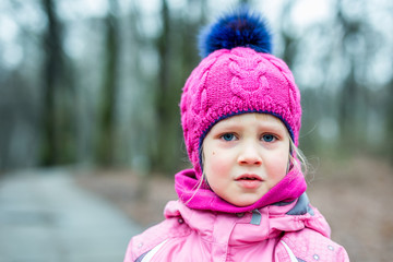 Portrait of little sad girl outdoor