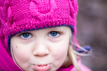 Portrait of little sad girl outdoor