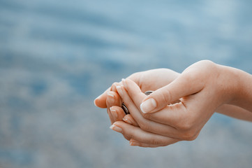 Handful of coins in palm female hands. Concept of saving and passive income