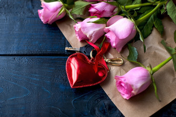 A bouquet of roses and biscuits as a gift for a day of lovers on a black background and a red heart