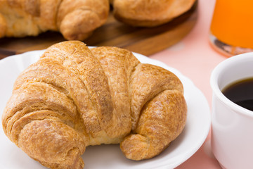 closed up fresh croissant on white dish