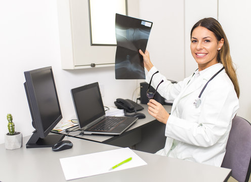 Female doctor looking at x-ray image of the patient in the hospital