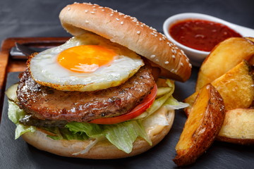 Burger with meat and eggs sunny side up
