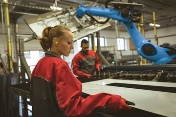 Female worker checking a glass sheet