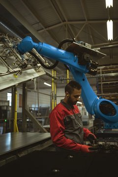 Male worker checking a machine part