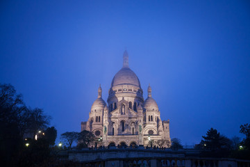 Sacre Coeur Basilica in Montmartre, Paris, illuminated during a winter night. The Basilica of the Sacred Heart of Paris is a Roman Catholic church and minor basilica..