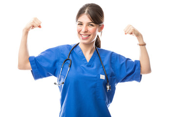 Female doctor acting as superhero flexing her arms © AntonioDiaz
