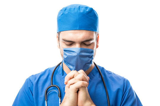 Doctor Saying A Prayer Before Surgery