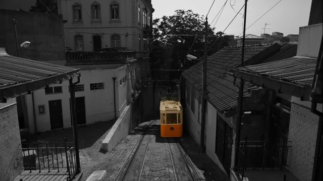 Black and white with selective color shot of the Elevador do Lavra funicular tram elevator, also known as Ascensor do Lavra, in Lisbon, Portugal, inaugurated in 1884