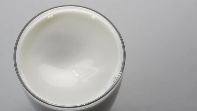 Pouring milk into glass, Slow motion
