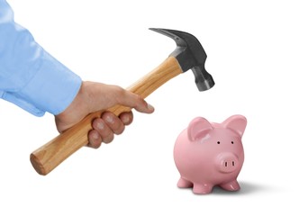 Businessman Hand with Hammer on a Piggy Bank