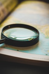 Closeup of a Magnifying Glass on an Atlas