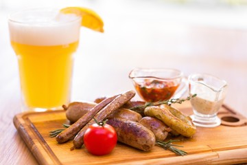 Meat on Cutting Board with Sauces and Drink