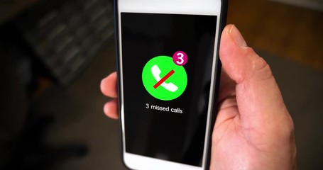 A man holds a smartphone showing the notification of receiving three missed calls.	 	