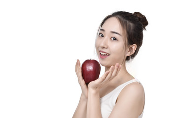 Happy healthy girl. Toothy smile portrait of a beautiful young woman, holding an apple, isolated on white.