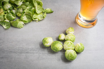 Brussel sprouts and a glass of beer on a stone background