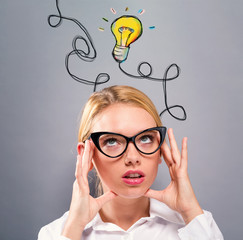 Light Bulb with business woman on a gray background