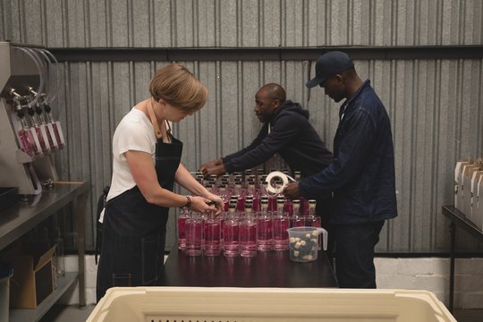 Workers packing gin bottles