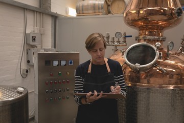 Female worker writing on clipboard
