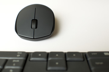 A gray wireless mouse and a keyboard