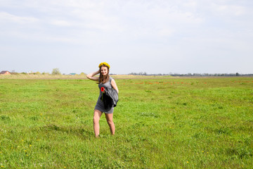 Beautiful fairy young girl in a field among the flowers of tulip