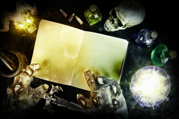 Halloween composition with mysterious bottles and black magic book. Top view.