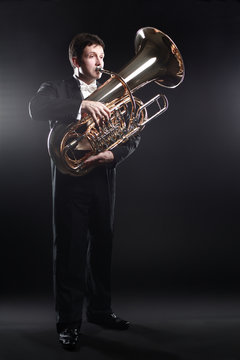 Tuba player brass instrument. Classical musician man horn player