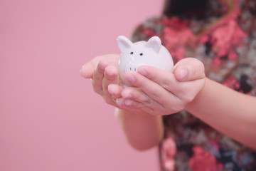 Little Piggy bank in hand.