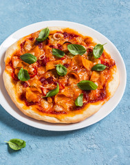 Sweet potato cheddar pizza on a blue background. Delicious appetizer or snack