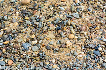 Smooth small stones on the sand