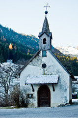 Fototapeta na wymiar small mountain church with snow