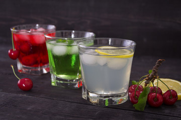 Icy refreshing fruit drinks. With fruit on a wooden background