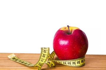 Diet and slimming concept. apple and tape measure