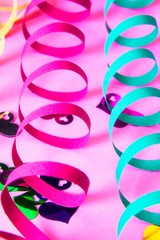 Fototapeta premium Party decoration. colorful streamers on pink background.