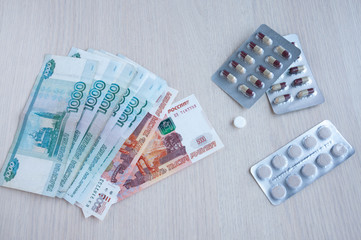 On the table are large Russian money and medicines