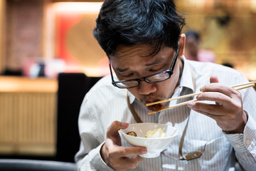 portrait man eating grilled.