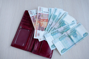 On the table are money Russian rubles and a red purse