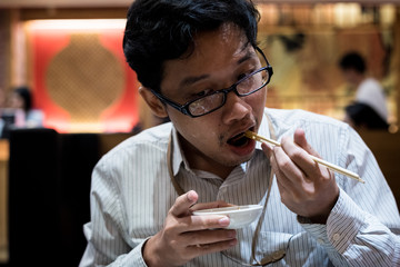 portrait man eating grilled.