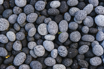 Rounded textured stones. Pebble.