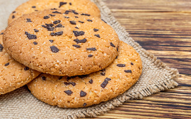 Chocolate chip cookies on sackcloth. Top view.