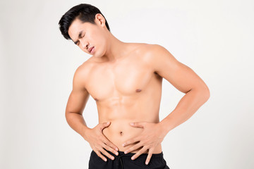 Man with stomachache feeling pain. Studio shot on white background.  Fitness and health concept