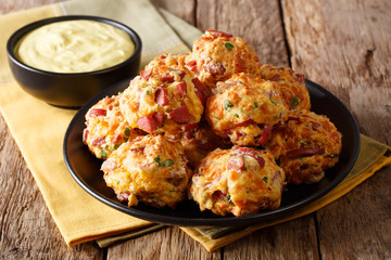 Homemade food: sausage balls with cheese cheddar and cilantro on a plate and sauce close-up. horizontal