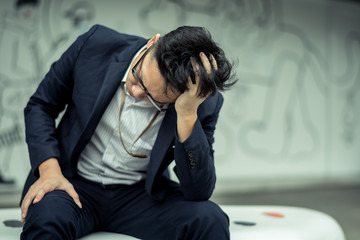 businessman stressed from work. anxiety in adult cause to depression and a problem in living that drag you down to feeling sadness,lonely and worried.