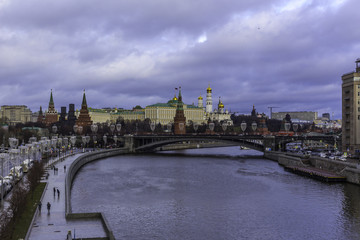 Fototapeta premium View of the Kremlin from the Patriarchal bridge . Parked tour buses in the foreground.Thaw in the middle of winter.