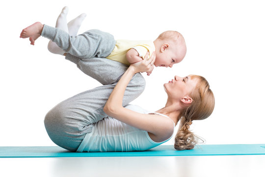 young mother does fitness exercises together with baby boy isolated