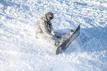 Snowboarder falling into the snow